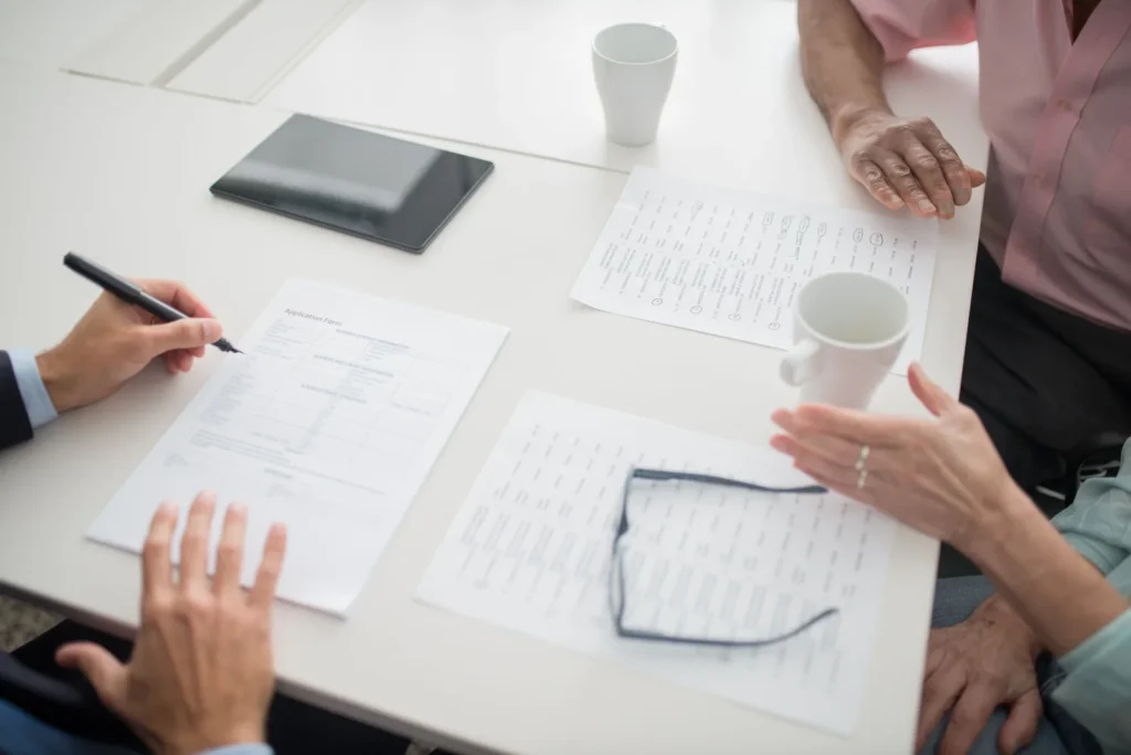 Colleagues reviewing documents together around a table